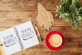 New mindset and new results text on notebook on wooden table with coffee cup and paper rocket. Business concept of positive Royalty Free Stock Photo