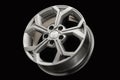 New modern alloy wheel close-up on a black background. Car beautiful