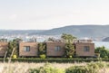New modern architectural building terraced houses with flat roofs in a row, sea and mountains background Royalty Free Stock Photo
