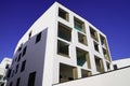 New modern buildings with white facade corner and blue sky in real houses on line for office and apartment