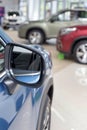 New modern cars at dealer showroom. Themed blur background with bokeh effect. Car auto dealership. Royalty Free Stock Photo