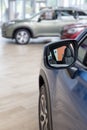 New modern cars at dealer showroom. Themed blur background with bokeh effect. Car auto dealership Royalty Free Stock Photo