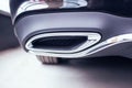 New modern chrome tailpipe on a black passenger car. Tuned muffler and beautiful bumper, transportation Royalty Free Stock Photo