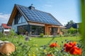 New modern eco friendly passive house with a photovoltaic system on the roof and landscaped yard. Solar panels on the Royalty Free Stock Photo