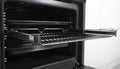 New modern electric oven built in black with screen, convention and grill, empty and open Royalty Free Stock Photo