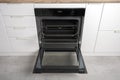 New modern electric oven built in black with screen, convention and grill, empty and open Royalty Free Stock Photo