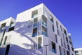 New modern facade white apartment real estate building exterior architecture in blue summer sky Royalty Free Stock Photo