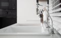 New modern faucet and kitchen room sink close up Royalty Free Stock Photo