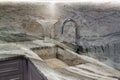 New modern faucet and kitchen sink close up made of stone as well as granite countertops in apartment. Close up view of chrome