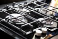 New modern gas stove with four burners for the kitchen, stainless steel surface. Cast iron grates Royalty Free Stock Photo