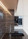 New modern kitchen with built in oven and chrome water tap. LED worktop illumination. Royalty Free Stock Photo