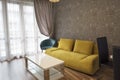 New modern living room. Yellow sofa near the window. New home. Interior photography. Wooden floor Royalty Free Stock Photo