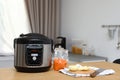 New modern multi cooker and products on table Royalty Free Stock Photo