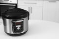 New modern multi cooker on table in kitchen Royalty Free Stock Photo