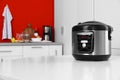 New modern multi cooker on table in kitchen Royalty Free Stock Photo