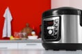 New modern multi cooker on table in kitchen Royalty Free Stock Photo