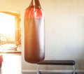 New modern punching bag in the hall for sports and martial arts on the background of the window in which the sunset, copy space Royalty Free Stock Photo