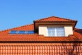 New, modern roof of red ceramic tiles, Dormer window protruding above the roof and three skylights. Royalty Free Stock Photo