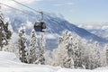 New modern spacious big cabin ski lift gondola against snowcapped forest tree and mountain peaks covered in snow Royalty Free Stock Photo