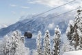 New modern spacious big cabin ski lift gondola against snowcapped forest tree and mountain peaks covered in snow Royalty Free Stock Photo