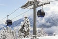 New modern spacious big cabin ski lift gondola against snowcapped forest tree and mountain peaks covered in snow Royalty Free Stock Photo