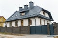 New modern two-storey private house. A white cottage with chimneys from the fireplace and stove. Luxury country house Royalty Free Stock Photo