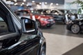 New modern unknown cars at dealer showroom. Themed blur background with bokeh effect. Car auto dealership Royalty Free Stock Photo