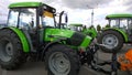 New modern versatile tractor Deutz Fahr with short wheelbase in agricultural machinery exhibition. Venue for farmers business. Sup