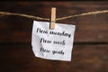 New Monday, New Week, New Goals - motivational quote. Crumpled paper note with text against wooden background Royalty Free Stock Photo