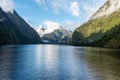 A new morning dawning at Doutful Sound, clouds hanging low in the mountains, Fiordland National Park, New Zealand