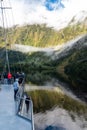 A new morning dawning at Doutful Sound, clouds hanging low in the mountains, Fiordland National Park, New Zealand