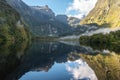 A new morning dawning at Doutful Sound, clouds hanging low in the mountains, Fiordland National Park, New Zealand