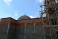 A new mosque under construction, building a new grand Masjid mosque in Cairo, Egypt, with a big dome and high minaret, wooden