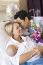 New mother with baby and husband in hospital Royalty Free Stock Photo