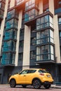 New multi-storey residential building with car parked in front. Modern house Royalty Free Stock Photo