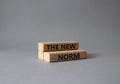 The new norm symbol. Concept words The new norm on wooden blocks. Beautiful grey background. Business and The new norm concept.