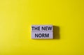 The new norm symbol. Concept words The new norm on wooden blocks. Beautiful yellow background. Business and The new norm concept.