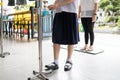 New normal,Asian student is using their foot to press the alcohol antiseptic gel,foot pedal on alcohol gel equipment,reduce touch,