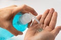 New Normal, Asian working woman washing hand by press blue alcohol sanitizer gel for protect safety infection and kill Covid-19