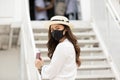 New normal of Asian young woman wearing protective mask holding passport ready to trevel at airplane