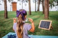 Back to school. Elementary scholars sitting on grass and wearing mask after open-air class Royalty Free Stock Photo