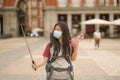 New normal holidays travel in Europe - young happy and beautiful Asian Japanese tourist woman in face mask taking selfie with Royalty Free Stock Photo
