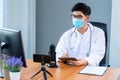 New normal, medical team wearing medical masks technology network team meeting concept. Doctor at a table discussing a patients