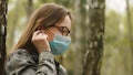 New normal. Portrait of a young woman with medical mask social distancing from others in the park