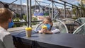 New normal reality, stay safe in street cafe, kids with medical mask waiting for breakfast Royalty Free Stock Photo