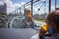 New normal reality, stay safe in street cafe, kids with medical mask waiting for breakfast Royalty Free Stock Photo