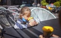 New normal reality, stay safe in street cafe, kids with medical mask waiting for breakfast Royalty Free Stock Photo