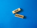 New normal symbol. Wooden blocks with words New normal. Beautiful blue background. Business and New normal concept. Copy space Royalty Free Stock Photo