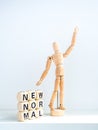 New Normal, words on wooden alphabet cube and wooden figure Royalty Free Stock Photo