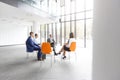 Business colleagues planning strategy while sitting on chairs during meeting Royalty Free Stock Photo